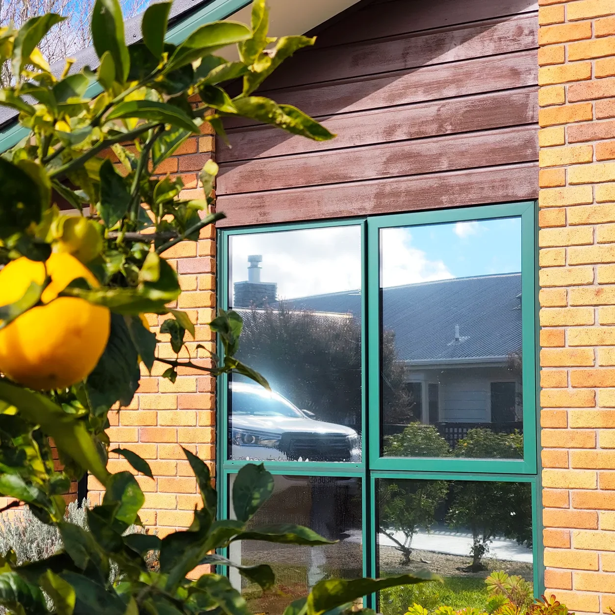 Reflective privacy film on a New Zealand brick home