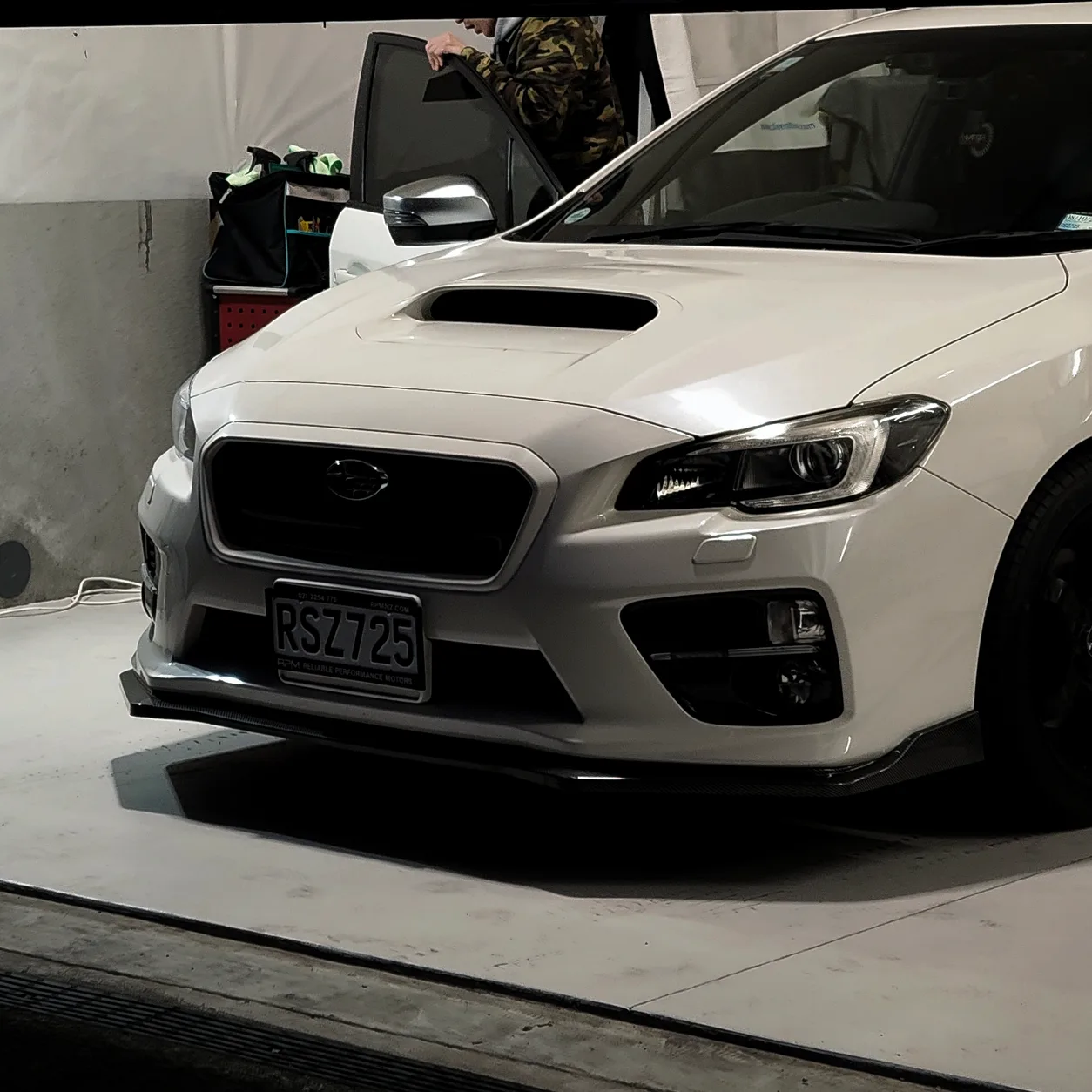 Zivent installer fitting window film to a Subaru WRX
